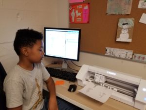 student on computer using Silhouette Cameo